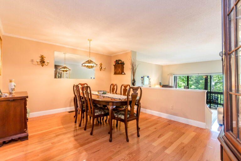 a dining room with brown wooden tables and chairs