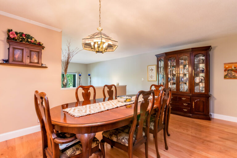 a dining room with brown wooden tables and chairs