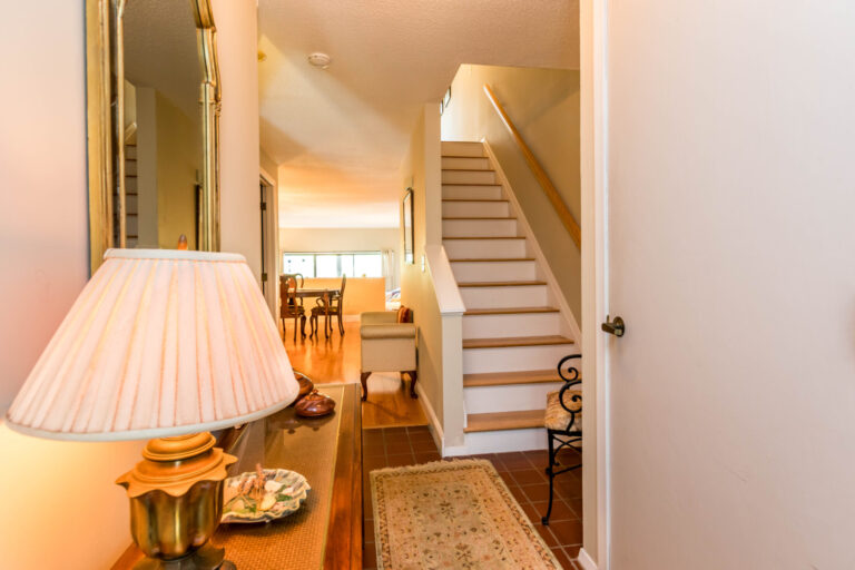 a view from the foyer leading to the stairs and living room