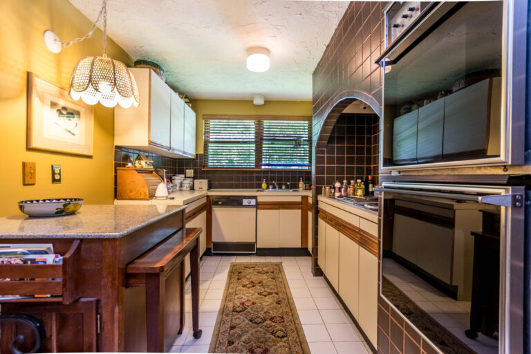 kitchen with brown backsplash, breakfast nook and stainless steel appliances