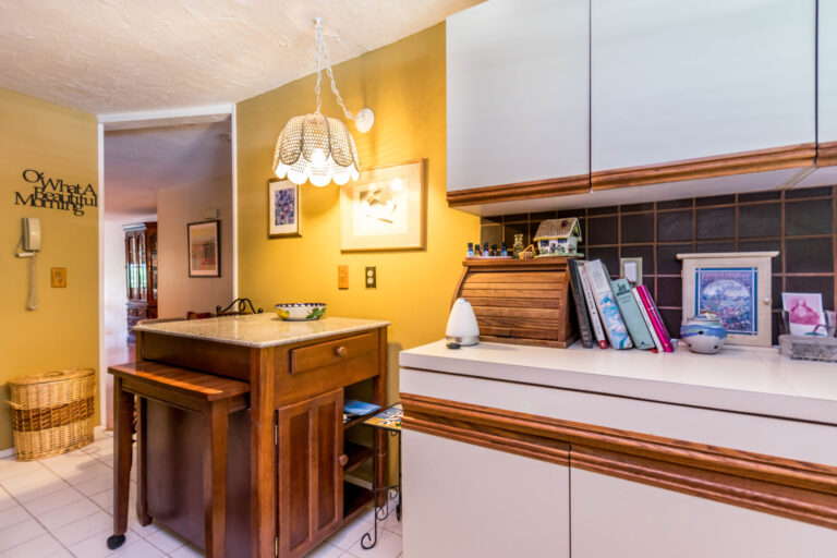 kitchen with brown backsplash, breakfast nook and stainless steel appliances