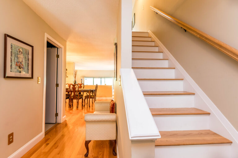 a view from the foyer leading to the stairs and living room