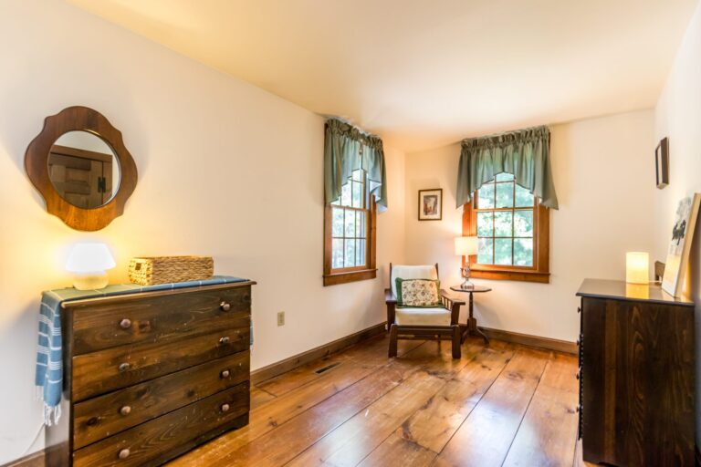 a master bedroom with bed, cabinet and side tables