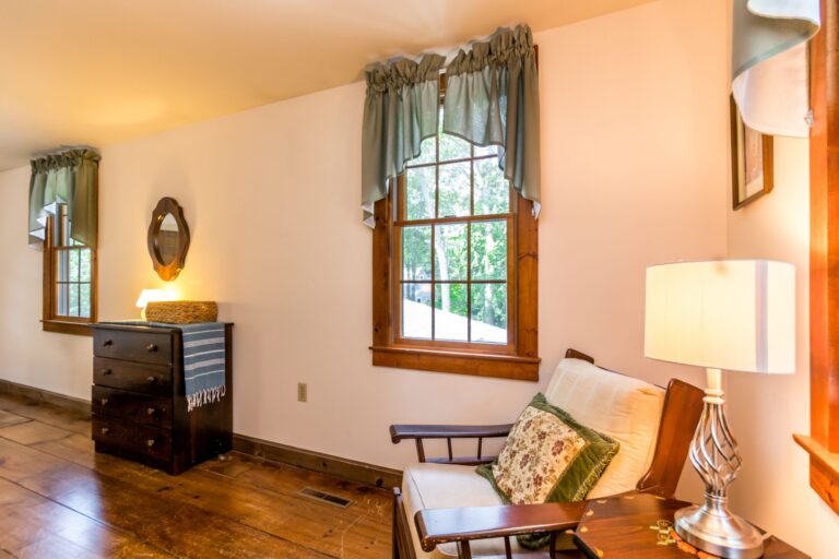 a master bedroom with bed, cabinet and side tables
