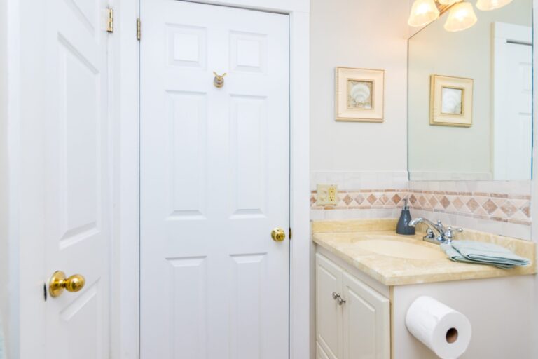 a bathroom with mirrors, tiolet, lavatory, and curtain shower