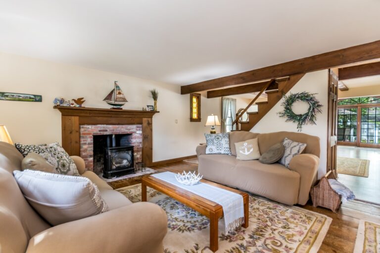 a living room with couch, tables, and fireplace