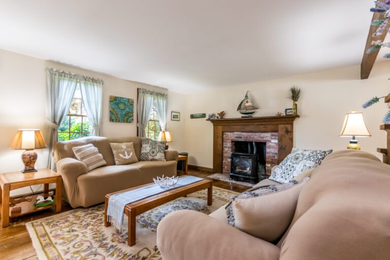 a living room with couch, tables, and fireplace