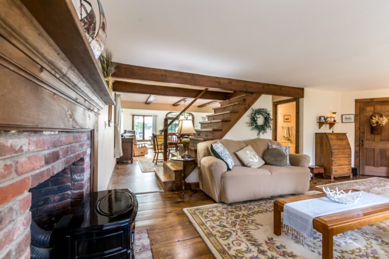 a living room with couch, tables, and fireplace