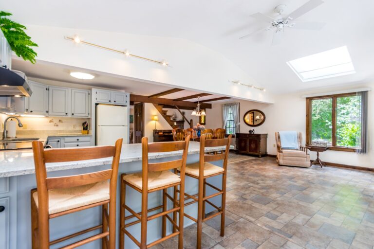 a kitchen with breakfast nook, white cabinets, and stainless steel appliance