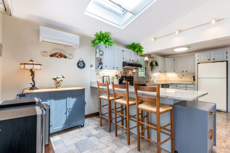 a kitchen with breakfast nook, white cabinets, and stainless steel appliance