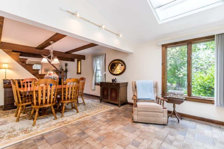a dining room with wooden chairs and table