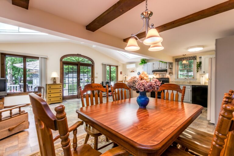 a dining room with wooden chairs and table