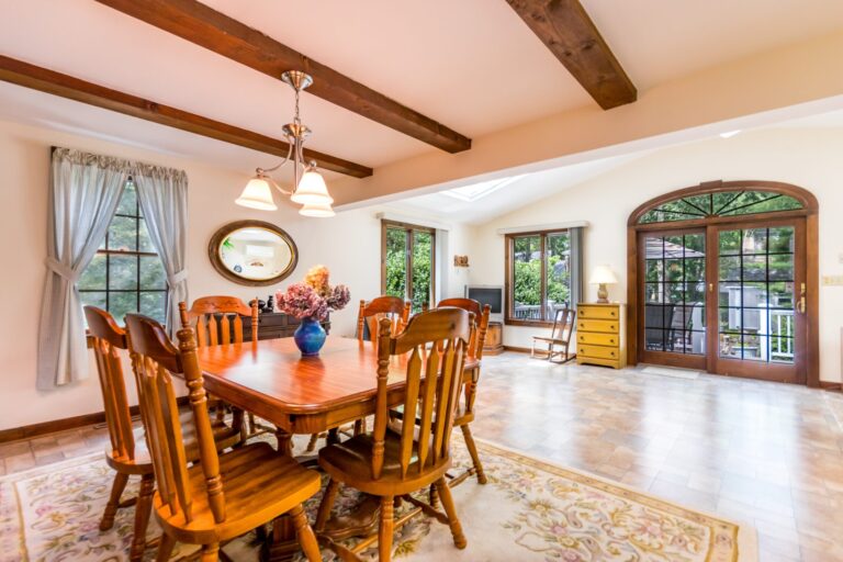 a dining room with wooden chairs and table