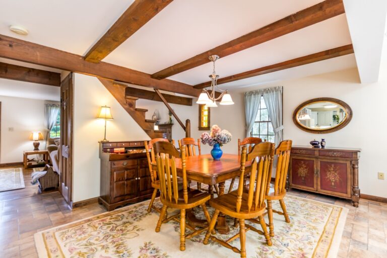 a dining room with wooden chairs and table