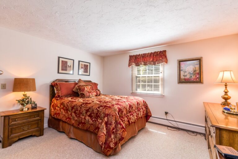 primary bedroom with a bed with red sheet