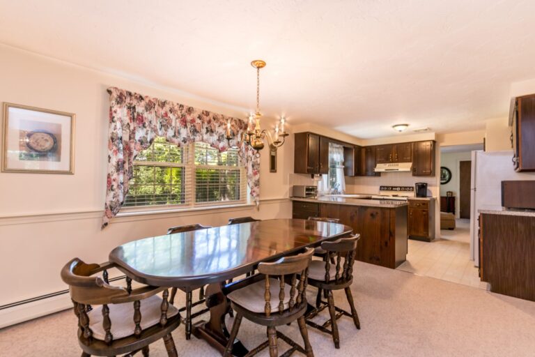 a dining room with wooden tables and chairs