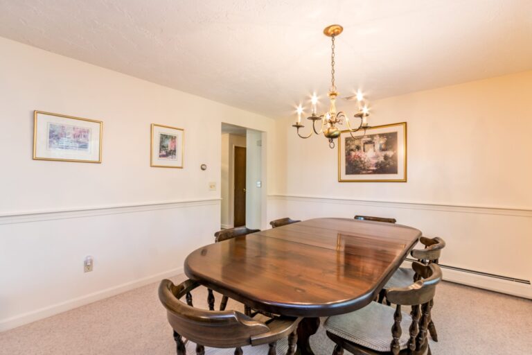 a dining room with wooden tables and chairs