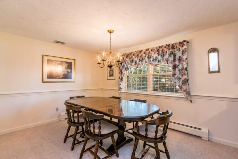 a dining room with wooden tables and chairs