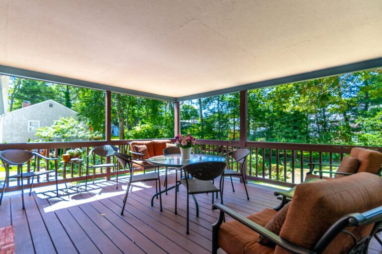 a covered deck with metal furnitures
