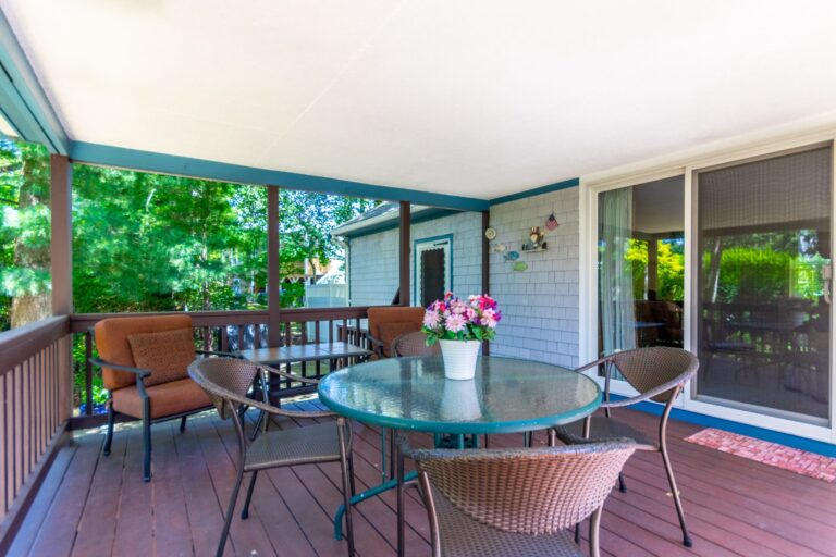 a covered deck with metal furnitures