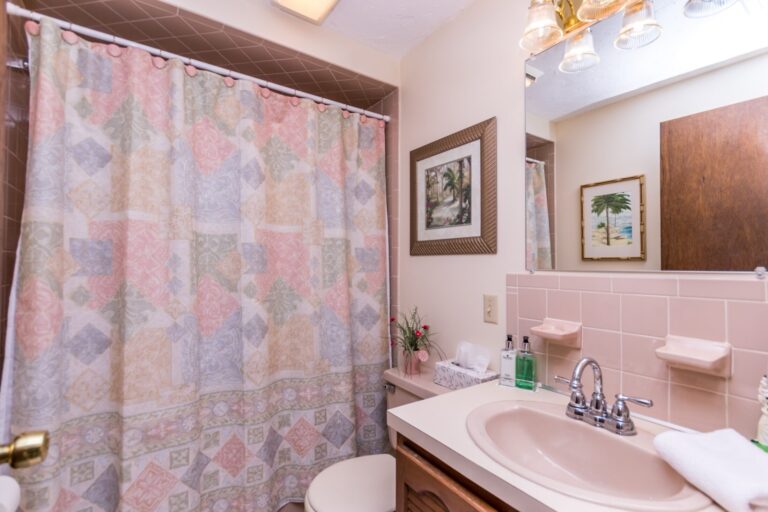 a small bathroom with lavatory, tiolet and shower