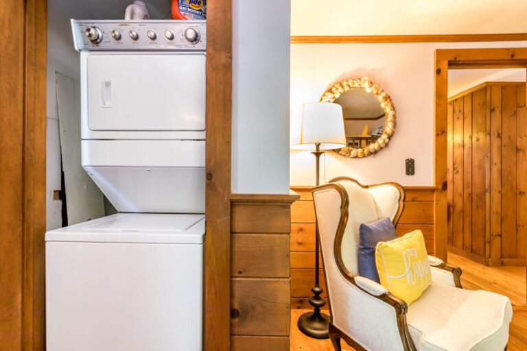 a cabinet containing the washer and dryer inside a bedroom