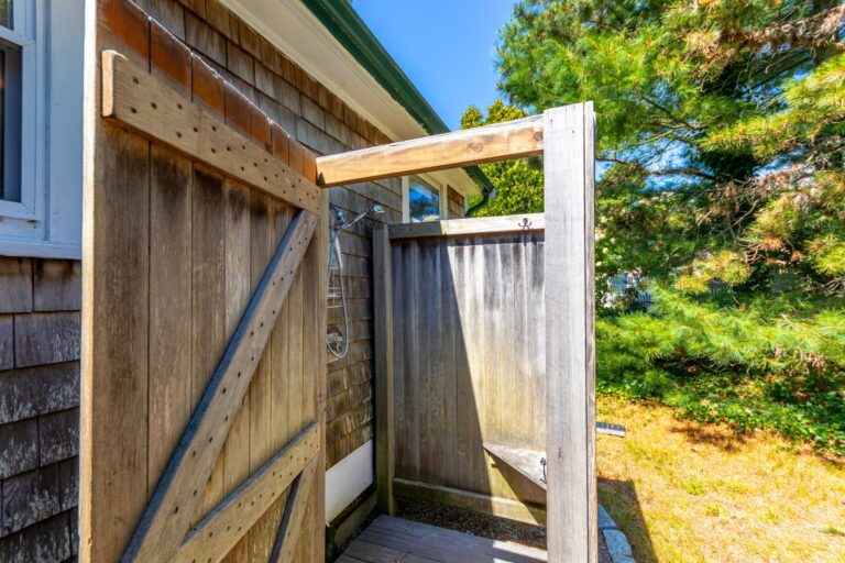 an outdoor shower with wooden enclosure