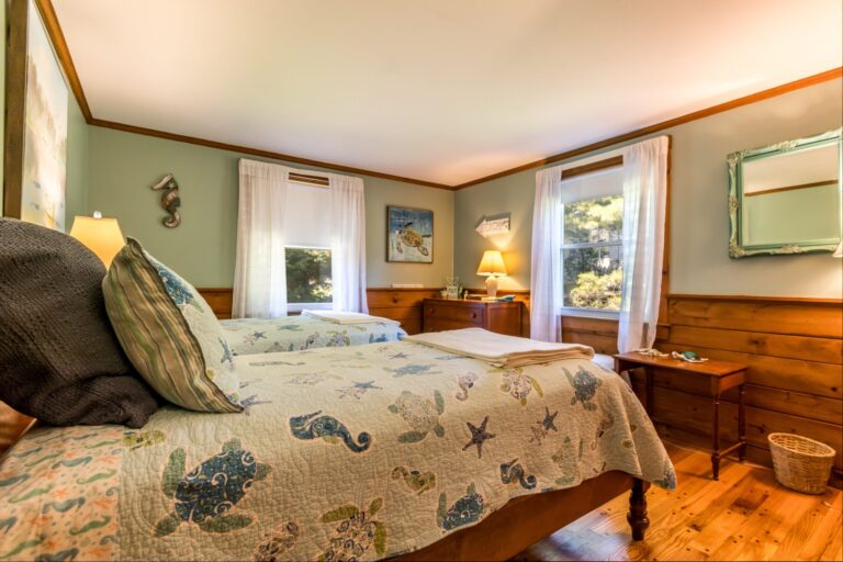 a bedroom with 2 beds and has ocean animal sheets