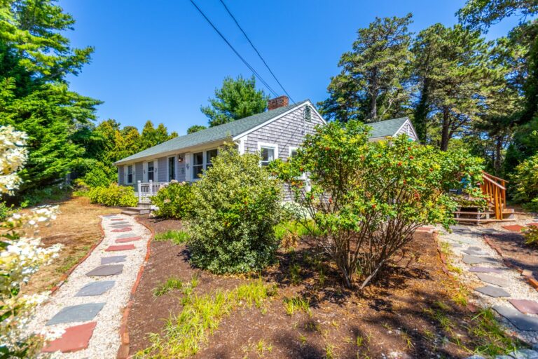 an entrance to the property 65 Lantern Ln surrounded by foliage