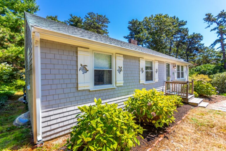front view of the property 65 Lantern Ln surrounded by foliage