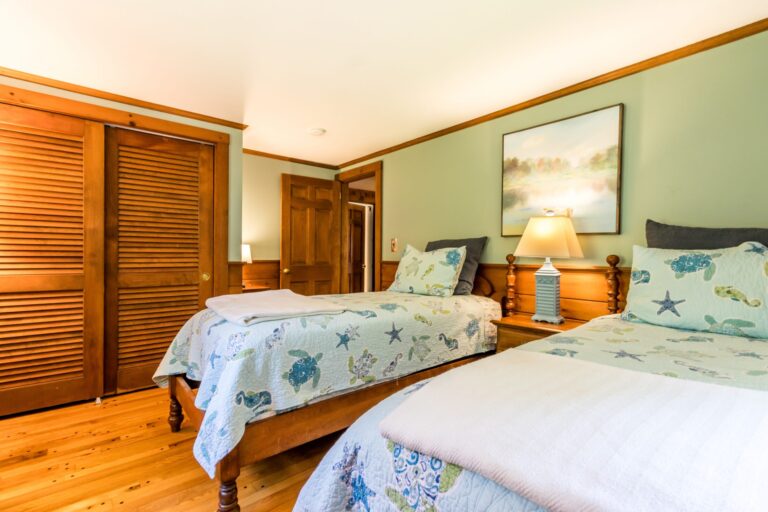 a bedroom with 2 beds and has ocean animal sheets