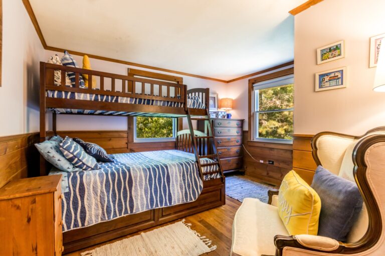 a bedroom with bunk beds and wooden furnitures