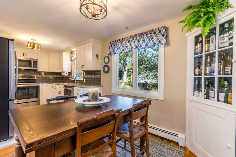 a wooden dining table near the kitchen