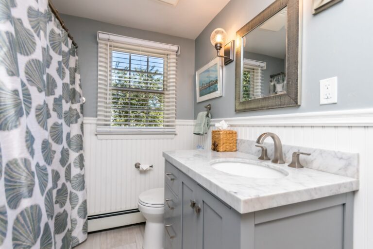 a bathroom with toilet, shower, lavatory and washer