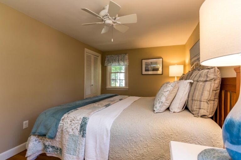 a bedroom with a bed with blue blanket