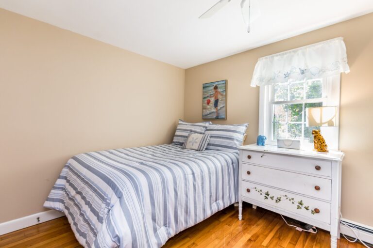 a oom with bunk beds and a regular sized bed with white dresser