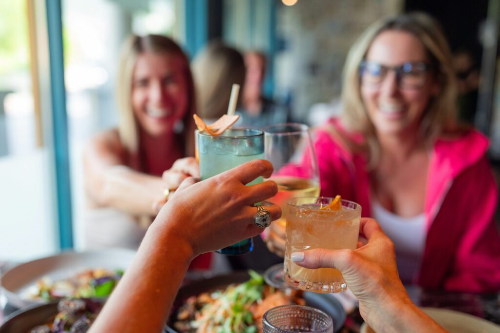 a group of people sitting at a table with drinks