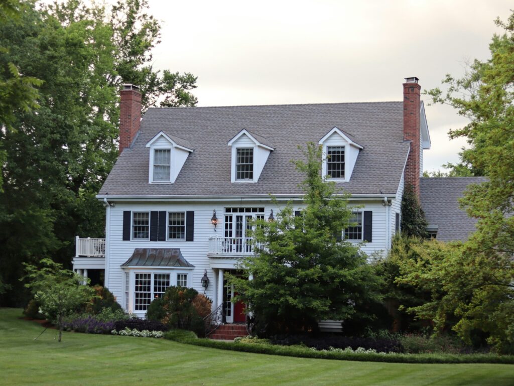 a large white house with black shutters and windows
