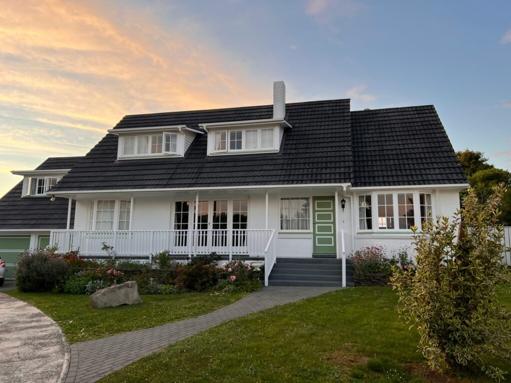 a large white house with a black roof