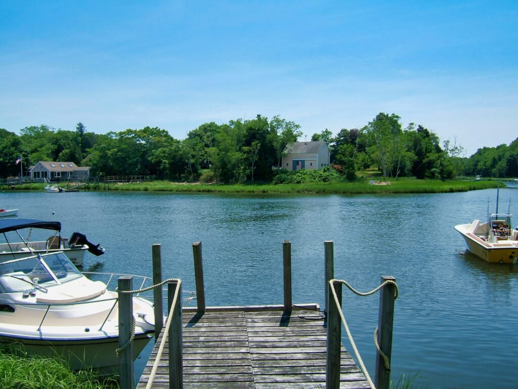 a wooden dock near a body of water during daytime