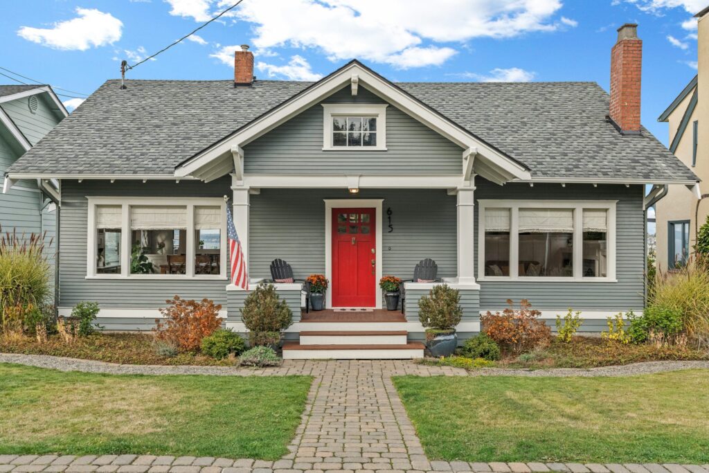 a gray house with red front door