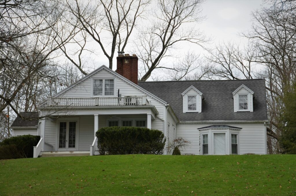 A large white house with a gray roof.