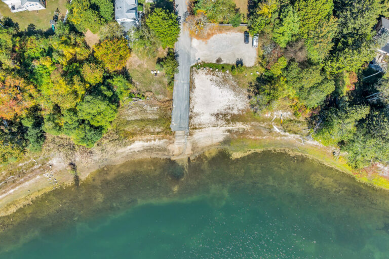 an aerial view of a boat launch near a pond