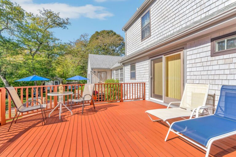 well-maintained rear deck featuring modern lounge chairs