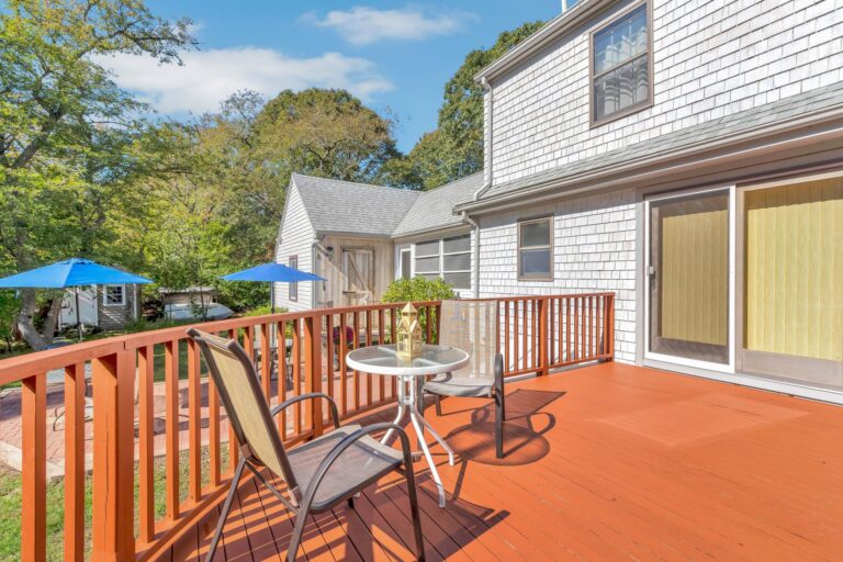 well-maintained rear deck featuring modern lounge chairs