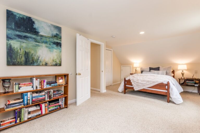 cozy bedroom features a slanted ceiling and a knee wall