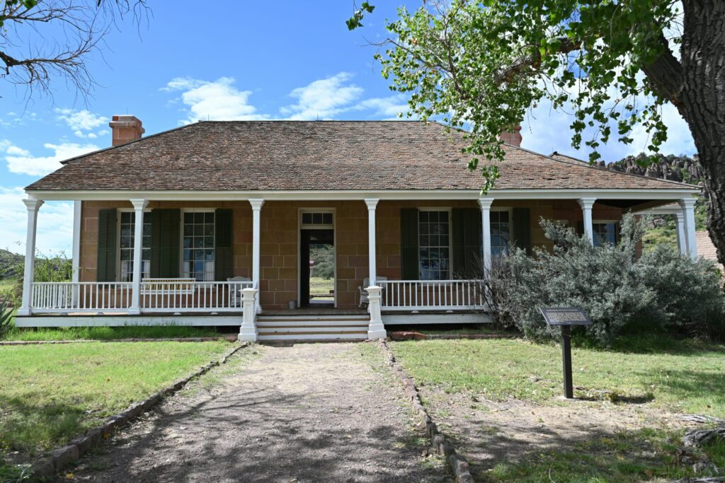Historic stone house with a wide wraparound porch
